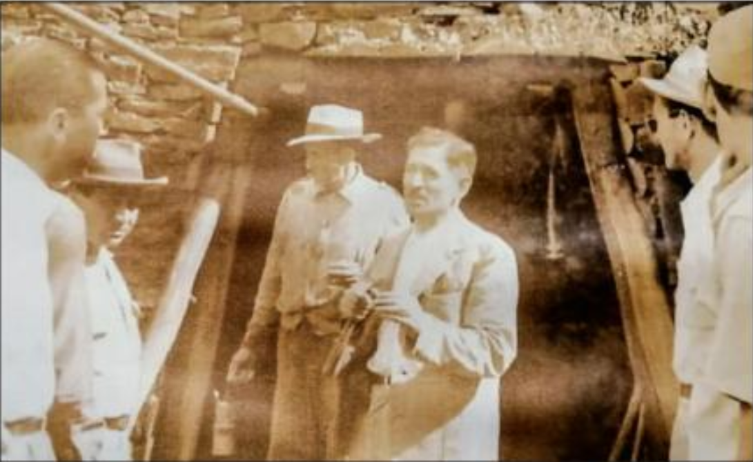Archival sepia photograph of miners inside a Dominican mine shaft